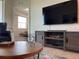 Living room with large TV and wood media console at 3161 Paradox Cir # 301, Kissimmee, FL 34746