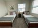 Bedroom with two twin beds, nightstand, and window coverings at 3161 Paradox Cir # 301, Kissimmee, FL 34746