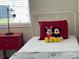 Charming bedroom with Mickey Mouse decor and a red nightstand at 3161 Paradox Cir # 301, Kissimmee, FL 34746