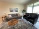 Cozy living room with gray sofa and two black accent chairs at 3161 Paradox Cir # 301, Kissimmee, FL 34746