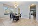 Elegant dining room with a glass-top table and four black leather chairs at 4204 Oakview Dr, Davenport, FL 33837