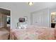 Bedroom with a king-size bed, TV, and access to another room at 4204 Oakview Dr, Davenport, FL 33837