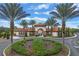 Gated community entrance with palm trees and landscaping at 4204 Oakview Dr, Davenport, FL 33837