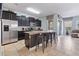Modern kitchen with stainless steel appliances and a breakfast bar at 4204 Oakview Dr, Davenport, FL 33837