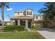 Two-story house with stone columns and landscaping at 4204 Oakview Dr, Davenport, FL 33837