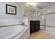 Spa-like bathroom with a large soaking tub, shower, and dark brown cabinets at 4204 Oakview Dr, Davenport, FL 33837
