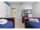 Bedroom with two twin beds, dresser, and access to a hallway at 4204 Oakview Dr, Davenport, FL 33837