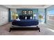 Spacious main bedroom with a king bed, blue accent wall, and large windows at 4204 Oakview Dr, Davenport, FL 33837