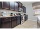 Well-equipped kitchen with dark wood cabinets and granite countertops at 4204 Oakview Dr, Davenport, FL 33837