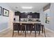 Updated kitchen featuring dark cabinetry, granite countertops, and stainless steel appliances at 4204 Oakview Dr, Davenport, FL 33837