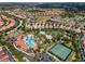 Aerial view of community with pools, tennis courts, and homes at 4204 Oakview Dr, Davenport, FL 33837
