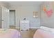 Charming bedroom with twin beds, dresser, and whimsical wall decor at 4204 Oakview Dr, Davenport, FL 33837