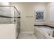 Elegant bathroom featuring a soaking tub and glass shower at 8843 Interlocking Ct, Davenport, FL 33896