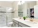 Modern bathroom with double vanity, marble tile, and a large shower at 8843 Interlocking Ct, Davenport, FL 33896