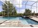 Relax in your screened-in pool and spa with ample lounge space at 8843 Interlocking Ct, Davenport, FL 33896