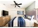 King-size bed with blue and white bedding and large TV at 8843 Interlocking Ct, Davenport, FL 33896