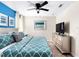 King-size bed with teal and gray bedding at 8843 Interlocking Ct, Davenport, FL 33896