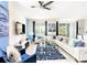 Spacious living area with white sectional sofa, blue accents, and large TV at 8843 Interlocking Ct, Davenport, FL 33896