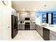Modern kitchen with gray cabinets, white countertops, and stainless steel appliances at 8843 Interlocking Ct, Davenport, FL 33896
