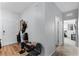 Light and airy foyer with wood-look floors and coat rack at 928 Orchid Grove Blvd, Davenport, FL 33837