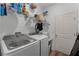 Laundry room with washer, dryer, and shelving at 928 Orchid Grove Blvd, Davenport, FL 33837