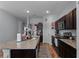 Kitchen boasts granite countertops, dark wood cabinets, and an island at 928 Orchid Grove Blvd, Davenport, FL 33837
