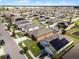 Aerial view of houses with solar panels and a community at 928 Orchid Grove Blvd, Davenport, FL 33837