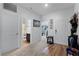 Bright foyer with wood-look floors, built-in shelving, and access to bathroom at 928 Orchid Grove Blvd, Davenport, FL 33837