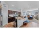 Open kitchen with granite island, stainless steel appliances, and view to dining area at 928 Orchid Grove Blvd, Davenport, FL 33837