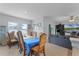 Formal dining room with wood table and chairs, and view to Gathering room at 928 Orchid Grove Blvd, Davenport, FL 33837