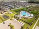 Aerial view of community pool, playground, and parking at 928 Orchid Grove Blvd, Davenport, FL 33837