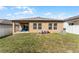 Spacious backyard with patio and grassy area at 928 Orchid Grove Blvd, Davenport, FL 33837