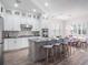 Modern kitchen with white cabinets, a granite island, and stainless steel appliances at 10564 Royal Cypress Way, Orlando, FL 32836