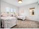Bright bedroom featuring two twin beds with decorative bedding and large windows at 10564 Royal Cypress Way, Orlando, FL 32836