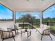 Screened balcony with comfortable seating and tranquil view at 10564 Royal Cypress Way, Orlando, FL 32836