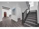 Elegant entryway with dark wood staircase and view into living area at 10564 Royal Cypress Way, Orlando, FL 32836