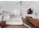 Main bedroom with a king-size bed and a large TV at 10564 Royal Cypress Way, Orlando, FL 32836