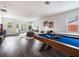 Spacious game room with pool table, sitting area, and TV at 10564 Royal Cypress Way, Orlando, FL 32836