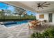 Spacious covered patio with dining area, ceiling fan, and access to the pool at 10564 Royal Cypress Way, Orlando, FL 32836