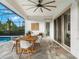 Covered patio features a dining set and sliding doors leading to the pool area at 10564 Royal Cypress Way, Orlando, FL 32836