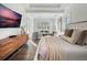 Main bedroom with large bed, sitting area, and wood dresser at 10564 Royal Cypress Way, Orlando, FL 32836
