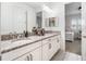Elegant bathroom with granite countertops, double sinks, and a view into a bedroom at 10564 Royal Cypress Way, Orlando, FL 32836