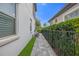 Private side yard with walkway and landscaping at 10564 Royal Cypress Way, Orlando, FL 32836