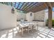 Covered outdoor kitchen and dining area with pergola at 10564 Royal Cypress Way, Orlando, FL 32836