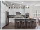 Modern kitchen featuring white cabinets, granite island, and stainless steel appliances at 10564 Royal Cypress Way, Orlando, FL 32836