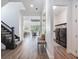 Long hallway with bench, stairs, and laundry room access at 10564 Royal Cypress Way, Orlando, FL 32836