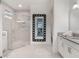 Modern bathroom with large shower, granite vanity, and elegant mirror at 10564 Royal Cypress Way, Orlando, FL 32836