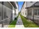 Shared walkway between homes with lush landscaping at 10564 Royal Cypress Way, Orlando, FL 32836