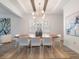 Modern dining room with wood table, white chairs, and stylish lighting at 10564 Royal Cypress Way, Orlando, FL 32836