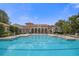 Resort-style pool with a clubhouse and lounge chairs at 10564 Royal Cypress Way, Orlando, FL 32836